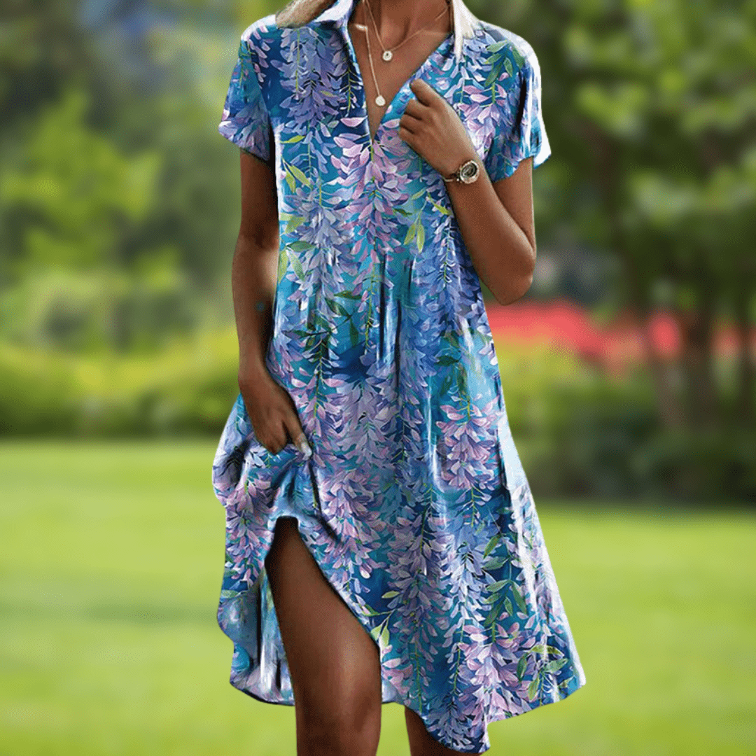 Woman wearing a blue floral dress in a garden setting