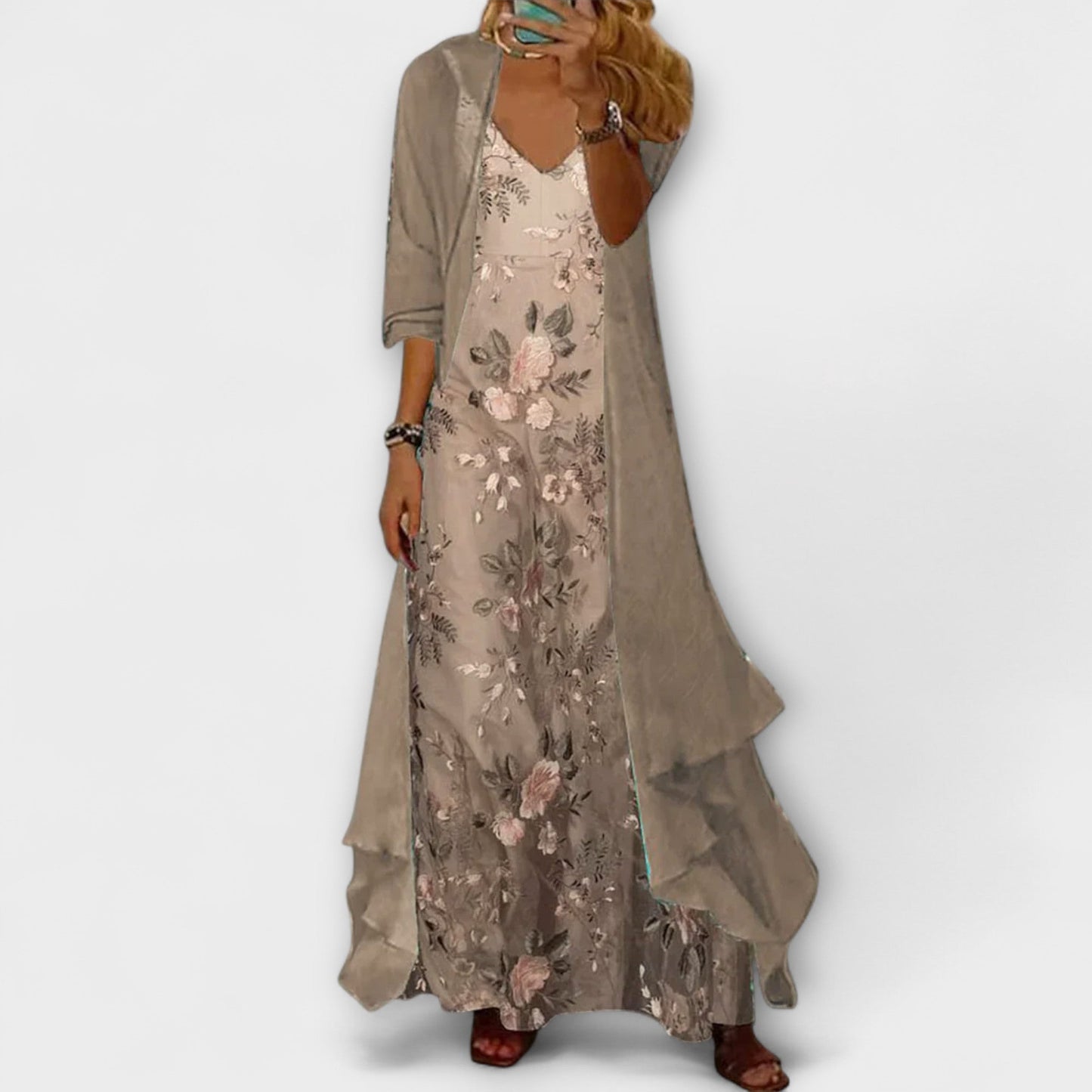 Woman wearing a floral dress with a plain background