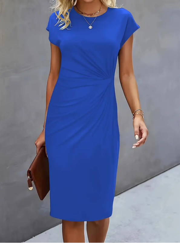 Woman wearing a blue dress against a gray background