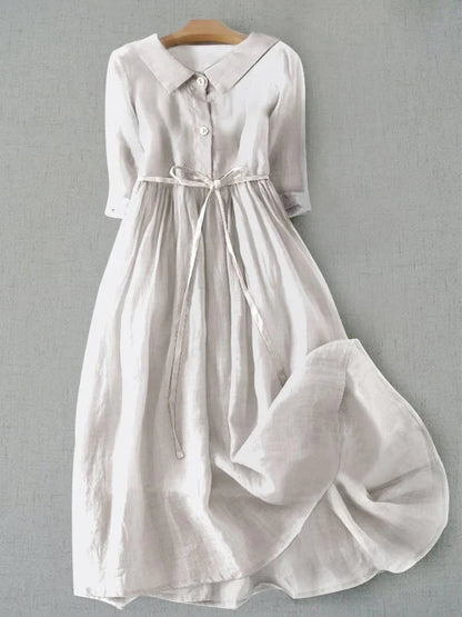 White dress with a collar on a gray background