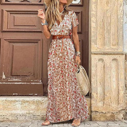 Woman in a floral dress standing in front of a rustic door.