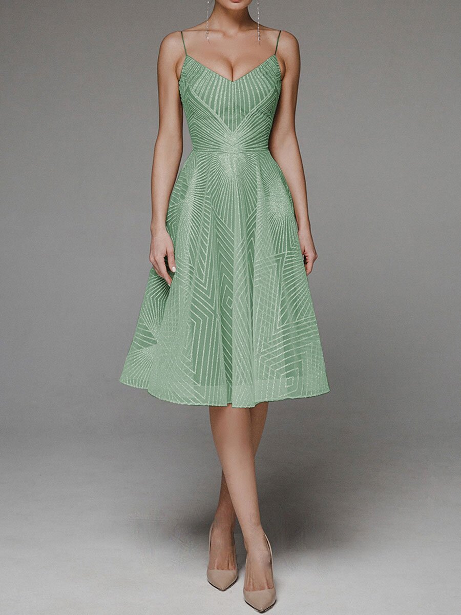 Green dress with geometric pattern on a gray background