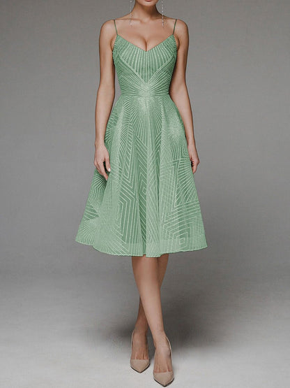 Green dress with geometric pattern on a gray background
