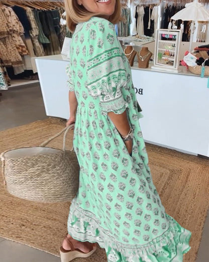 Woman wearing a green floral dress in a clothing store.