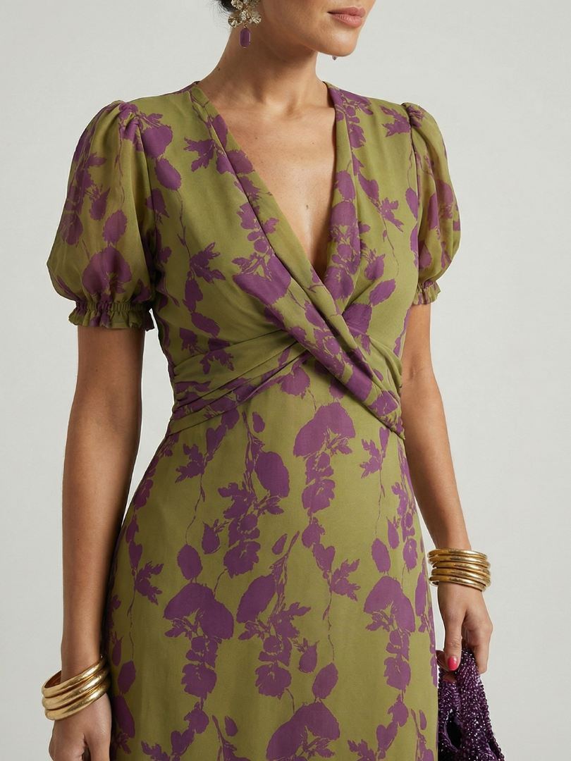 Green and purple floral dress with puff sleeves on a neutral background