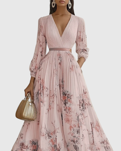 Woman wearing a pink floral dress holding a gold handbag on a white background