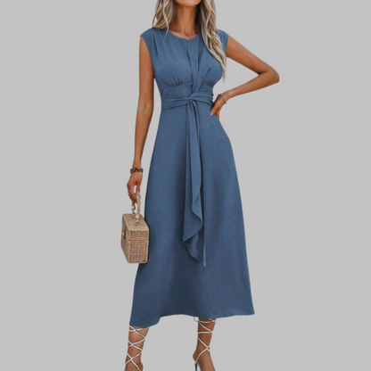 Woman wearing a blue dress with a plain background