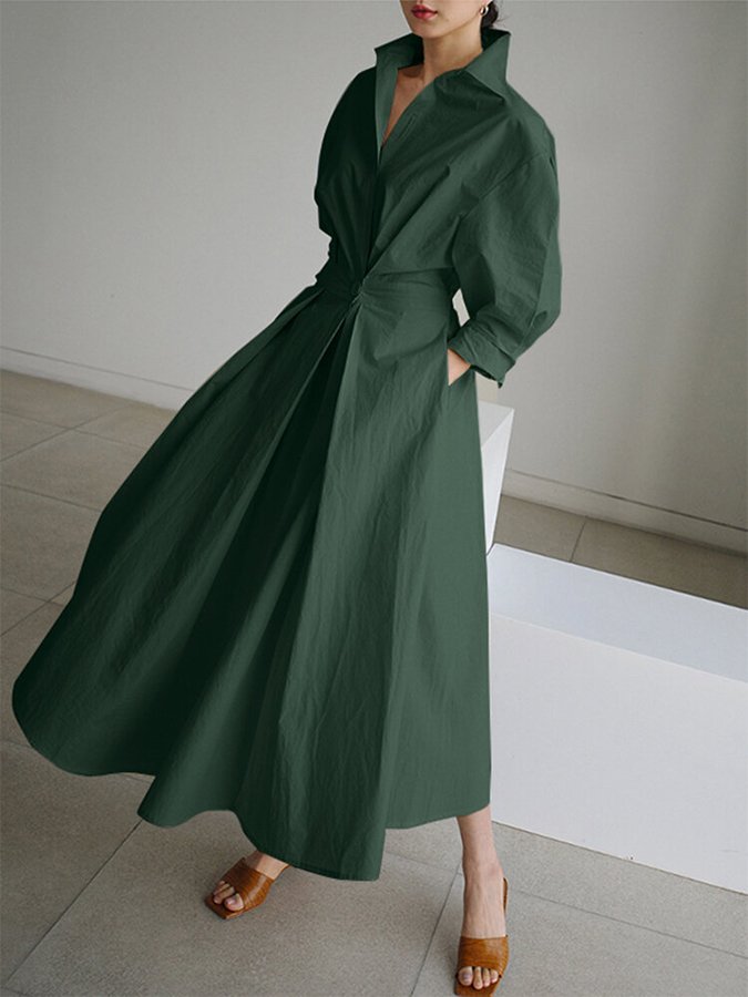 Woman wearing a long green dress in an indoor setting