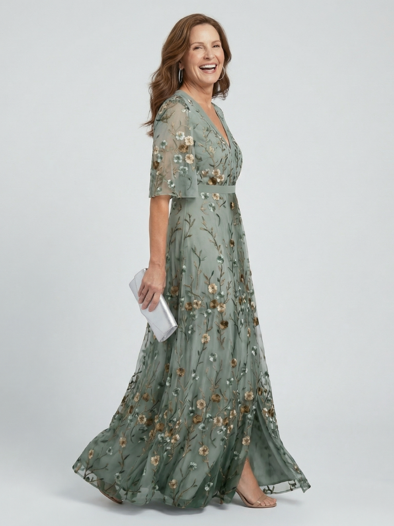 Woman wearing a floral dress on a plain background