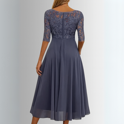 Gray dress with lace detailing on a gray background