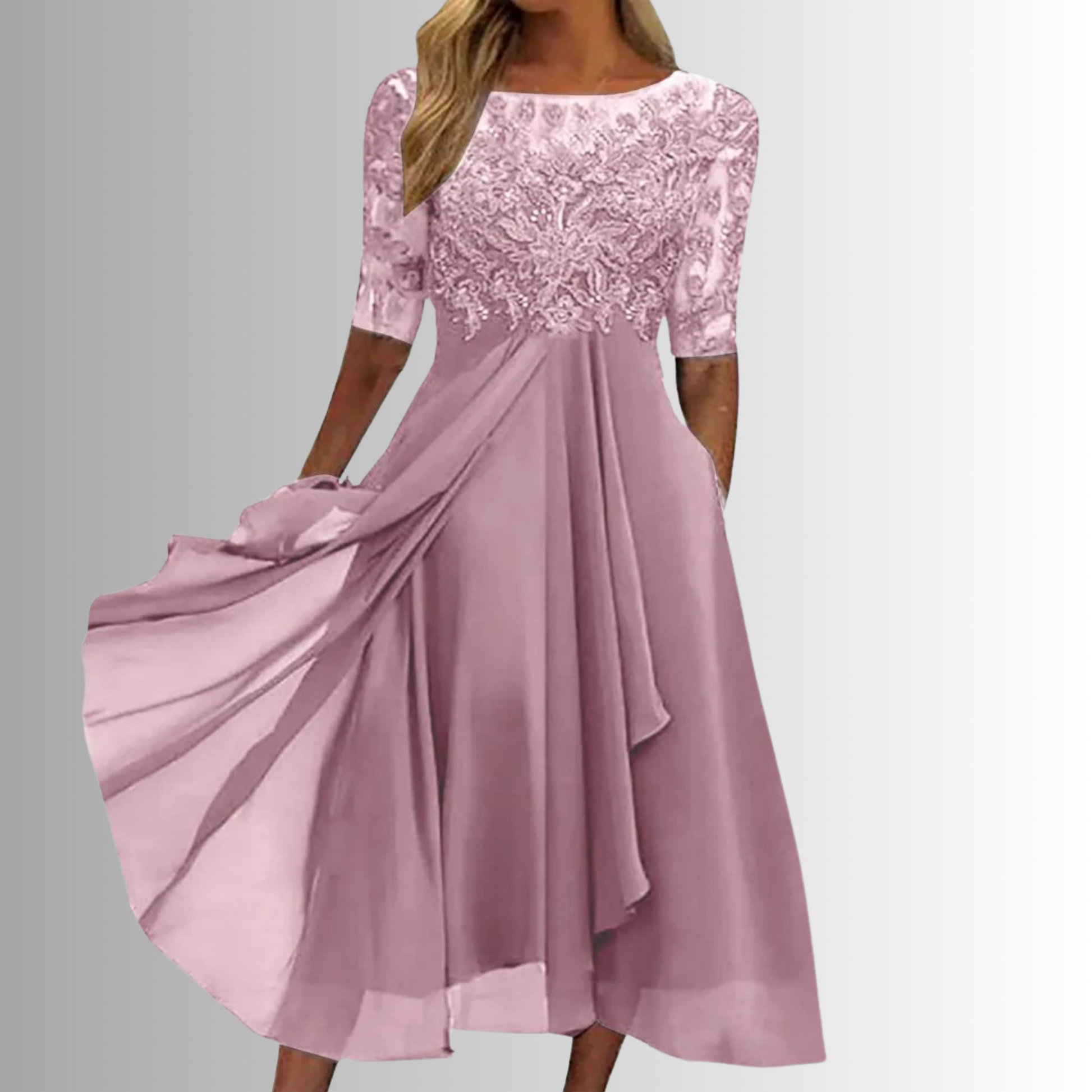 Pink lace dress with flowing fabric on a gray background