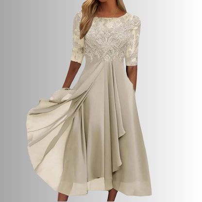 Beige dress with lace top on a plain background