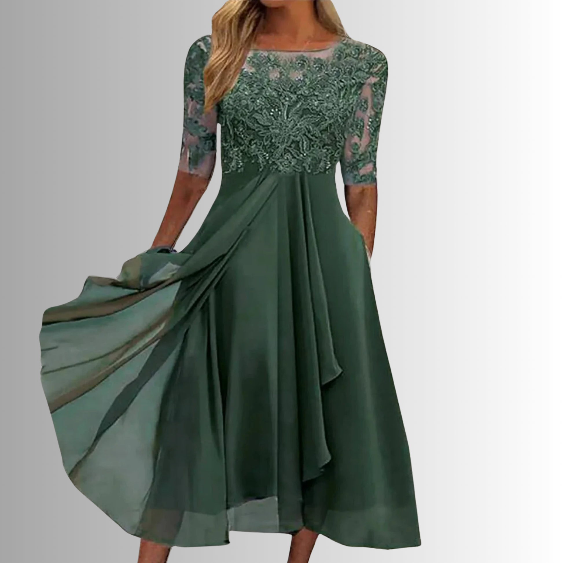Green dress with floral lace top on a plain background