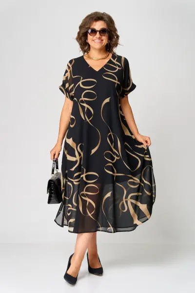 Woman wearing a black dress with gold patterns on a white background