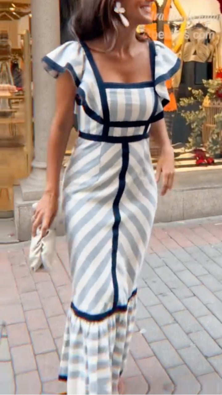 Woman wearing a striped dress on a city street