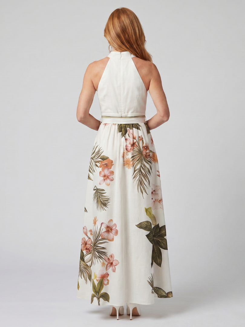 Woman wearing a white halter top and floral skirt on a plain background