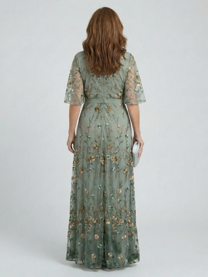 Woman wearing a green floral dress on a white background