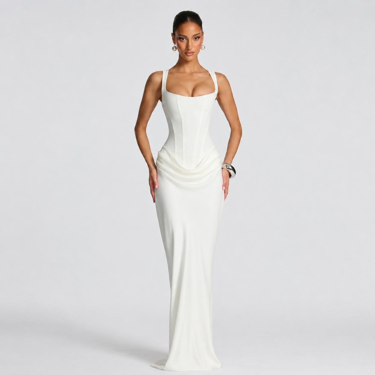 Woman wearing a white evening gown on a plain background