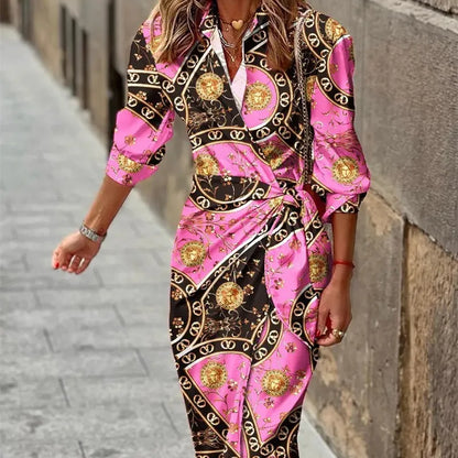 Woman wearing a pink and black patterned dress on a street.