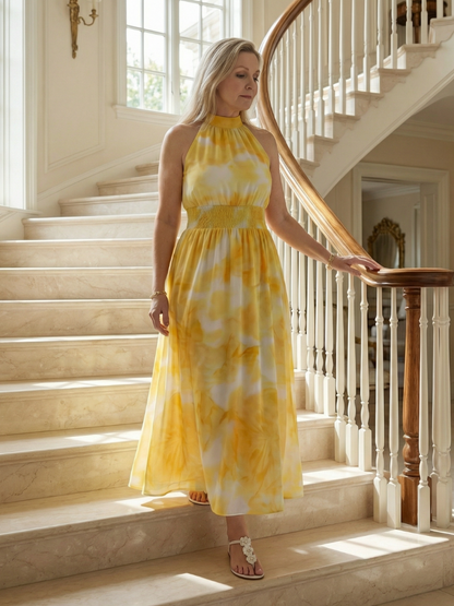 Woman in a yellow and white dress standing on a staircase