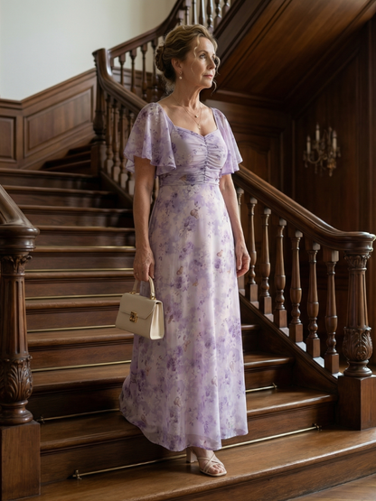 Woman in a floral dress standing on a wooden staircase