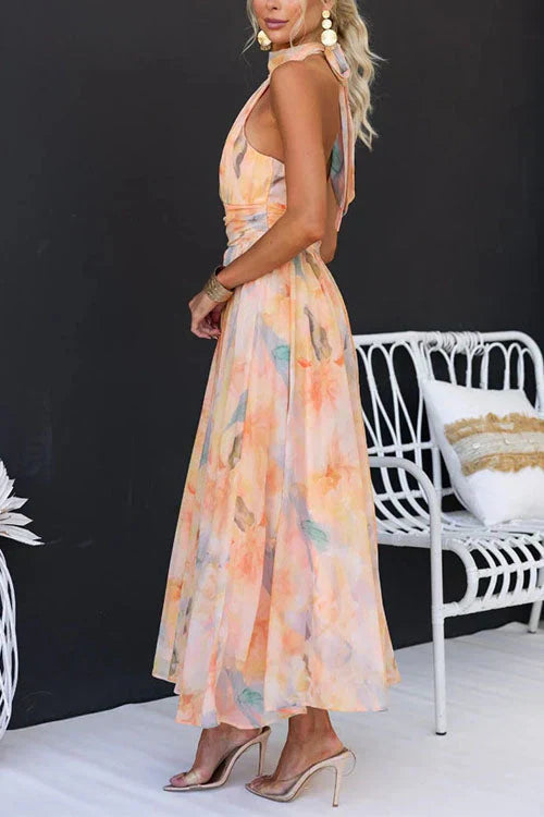 Woman wearing a colorful dress standing in front of a white bench with a black background