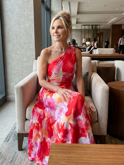 Woman in a colorful dress sitting in a modern indoor setting