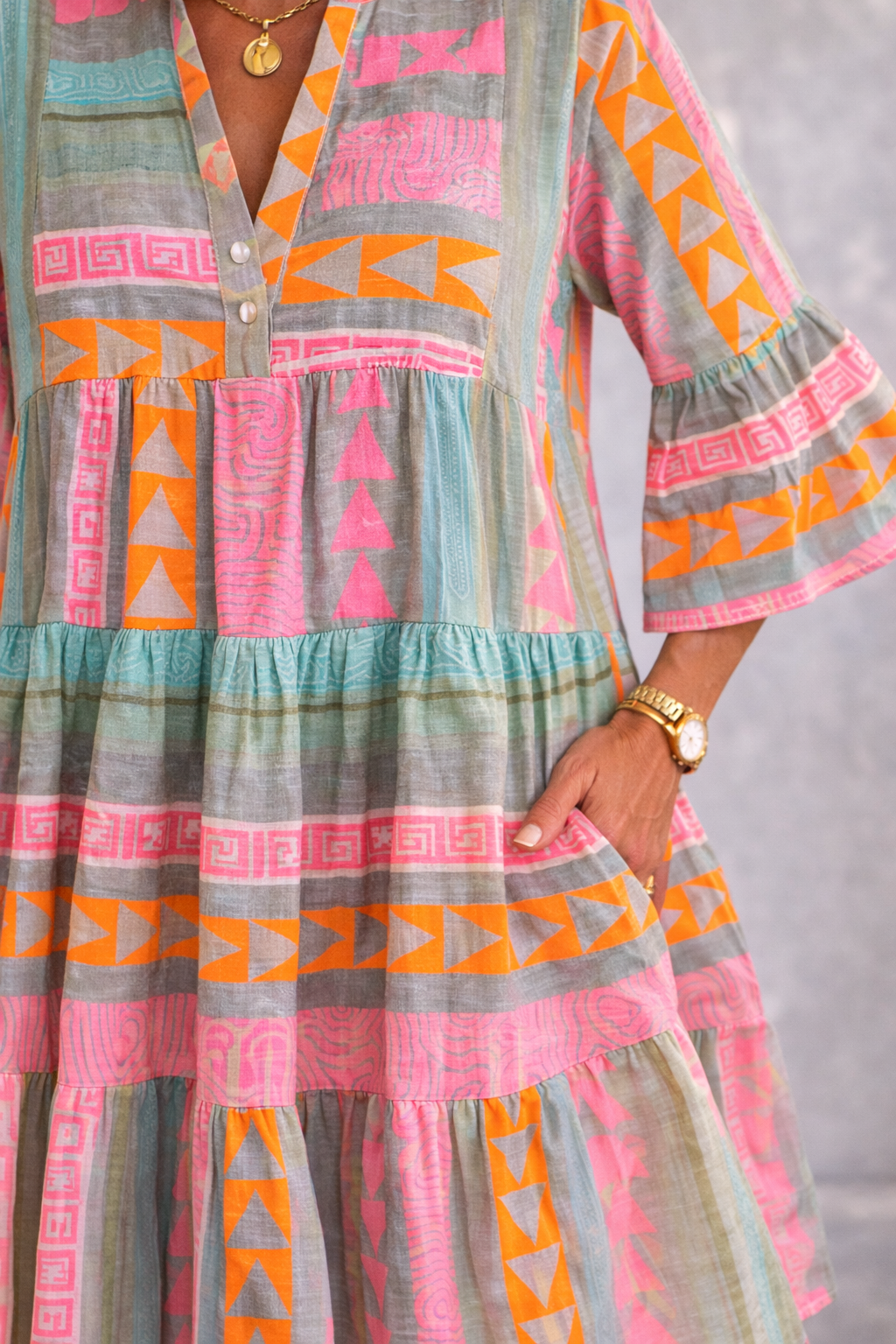 Colorful patterned dress with geometric designs on a plain background