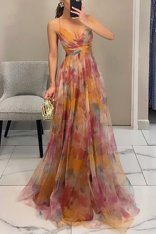 Woman wearing a colorful floral dress in an indoor setting.