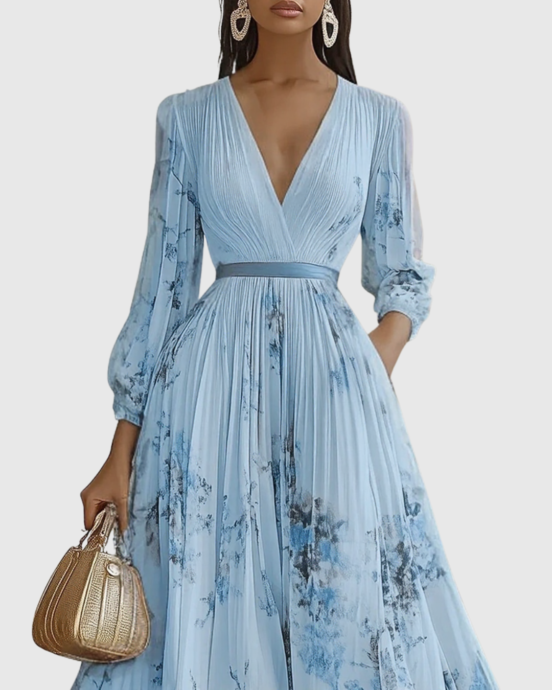Woman wearing a light blue floral dress holding a beige handbag against a white background
