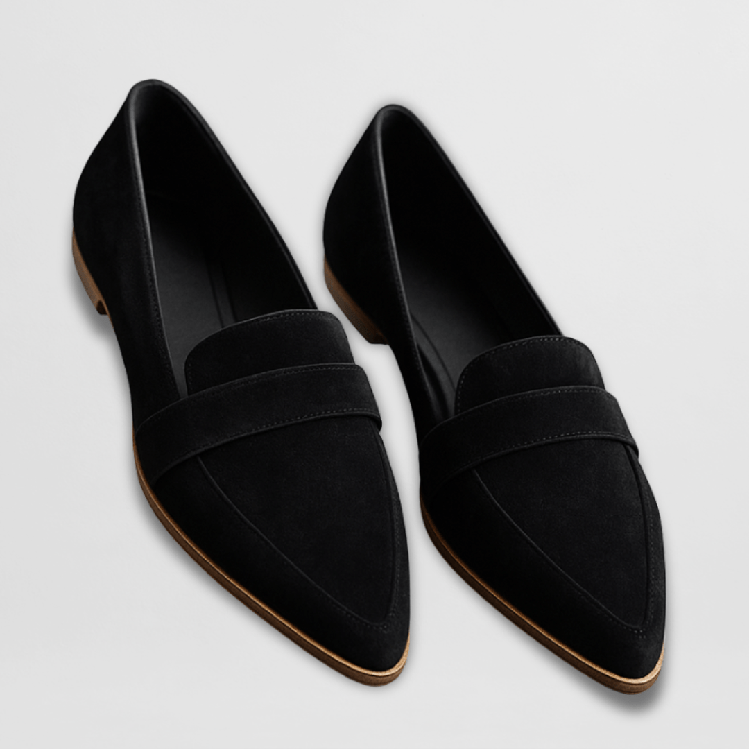 Pair of black loafers on a light gray background