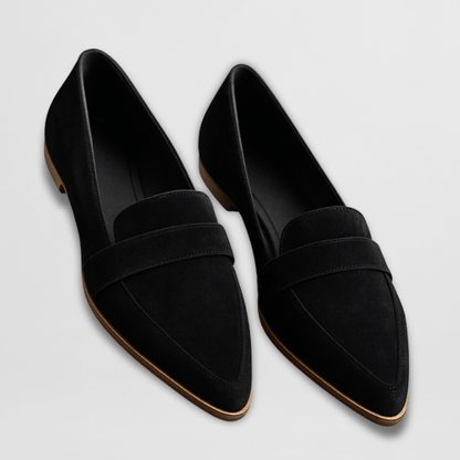 Pair of black loafers on a light gray background