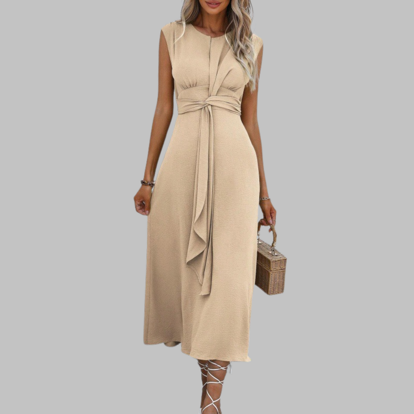 Woman wearing a beige dress with a belt on a gray background
