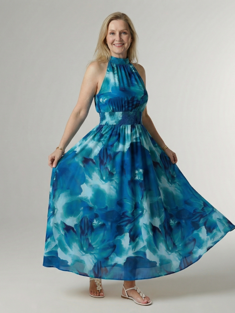 Woman wearing a blue floral dress against a plain background