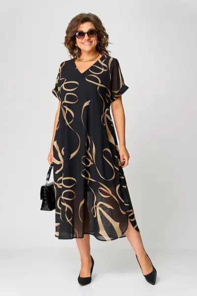 Woman wearing a black dress with gold patterns on a white background