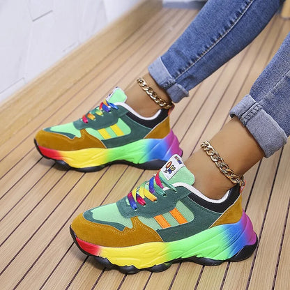 Colorful sneakers with rainbow accents worn on a wooden floor.