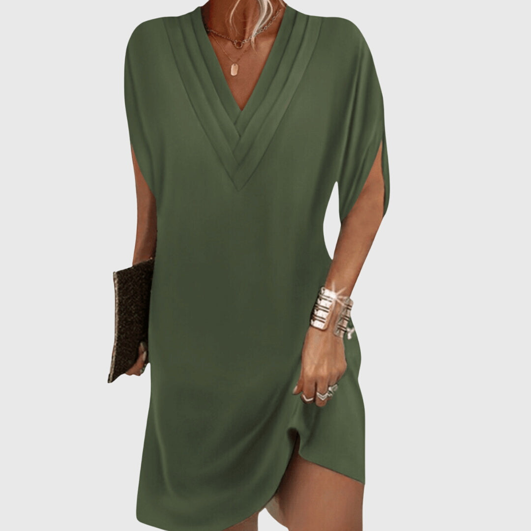 Green dress worn by a person on a white background