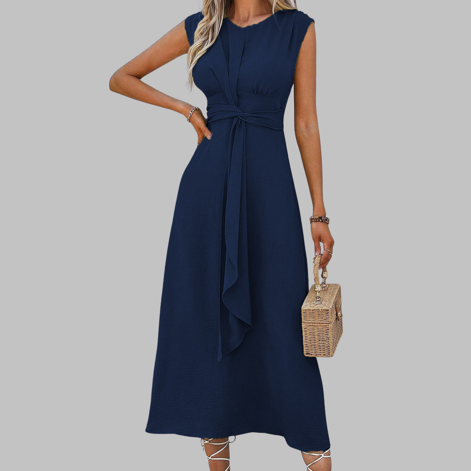 Navy blue dress worn by a person on a gray background