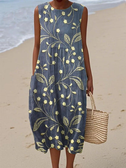 Woman wearing a blue floral dress on a beach