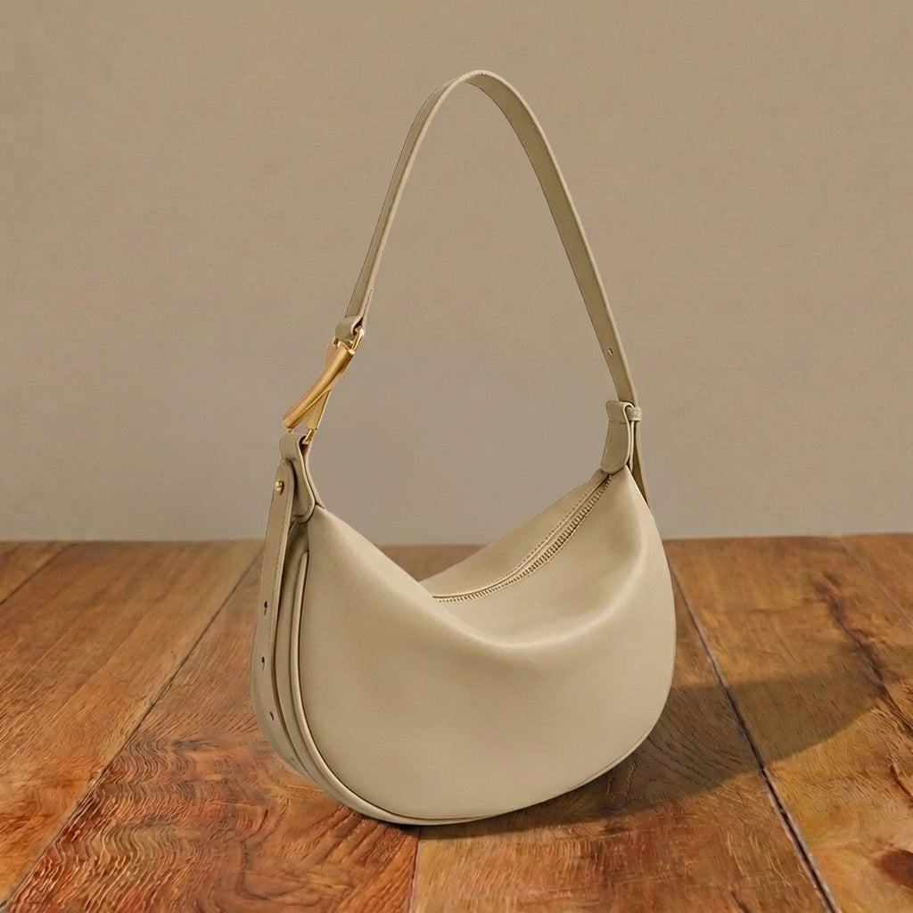 Beige leather purse on a wooden surface with a neutral background