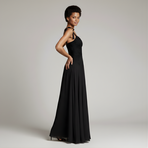 Woman wearing a black evening gown against a plain background