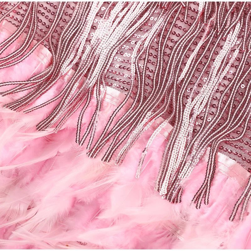 Close-up of pink fabric with decorative fringe and sequin details