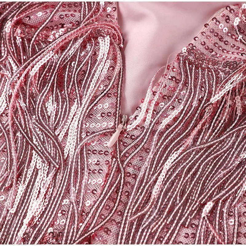 Close-up of a pink sequined fabric with a zipper