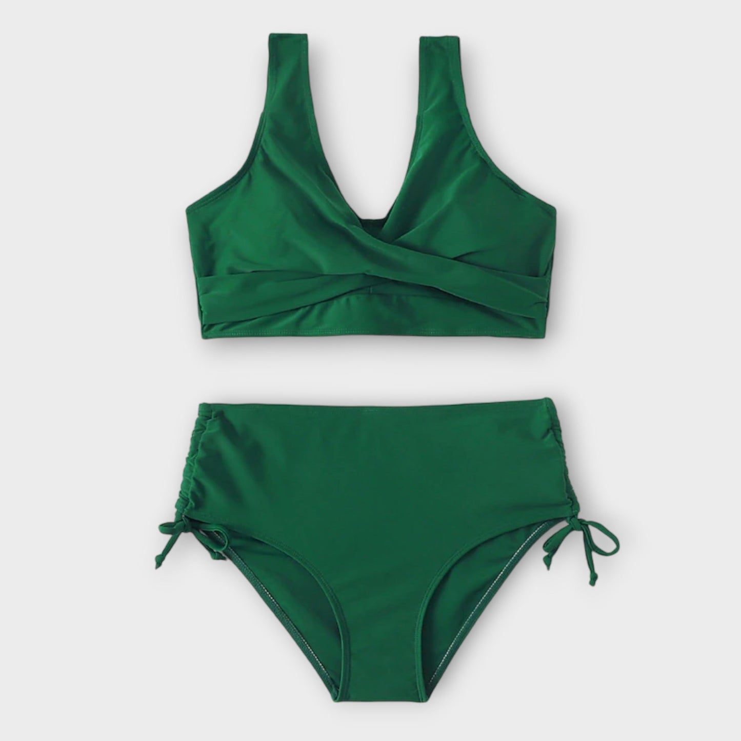 Green bikini set on a light gray background