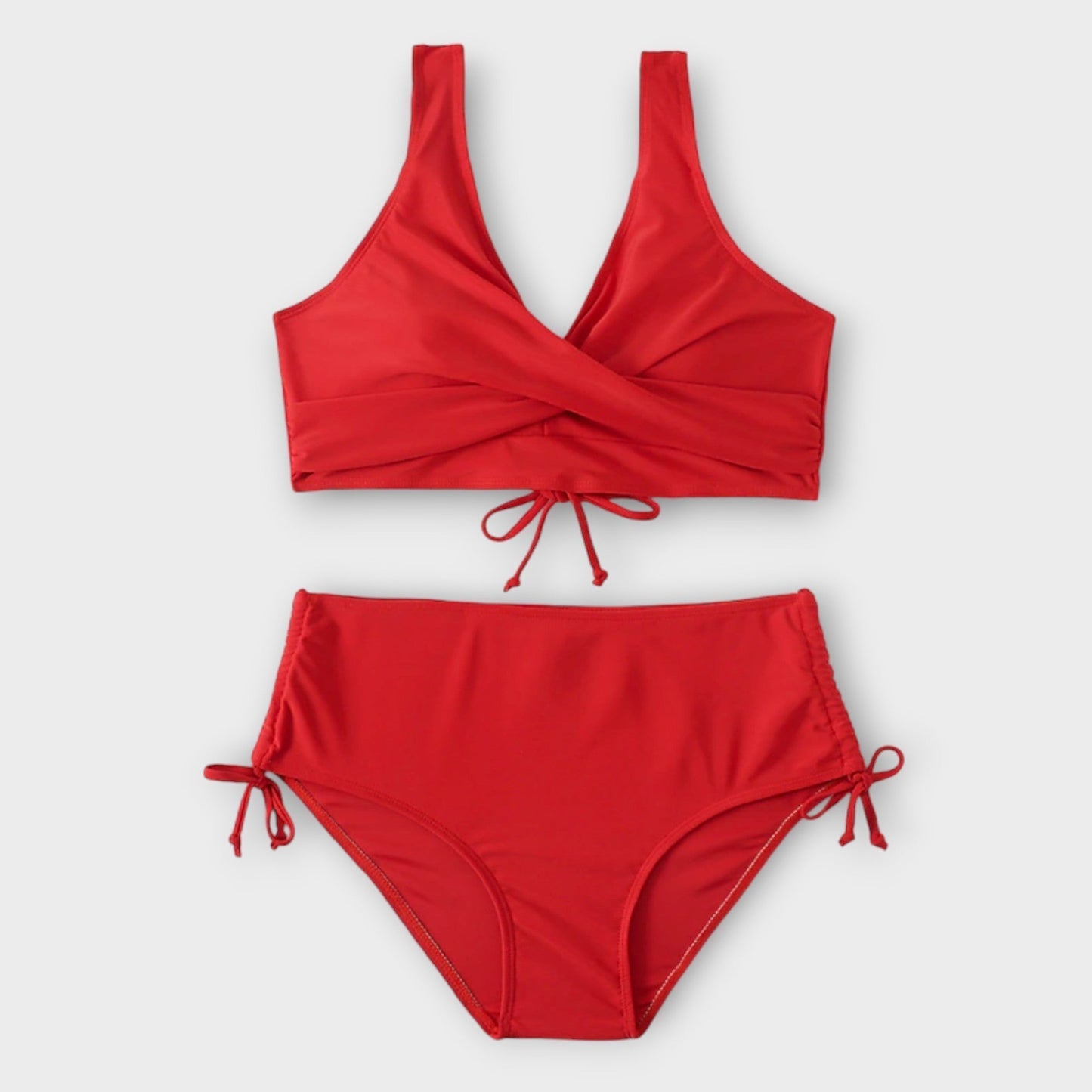 Red bikini set on a light gray background