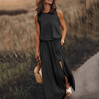 Woman in a black sleeveless dress standing on a path with a blurred natural background