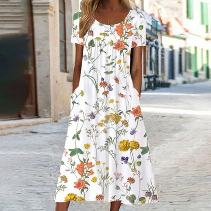 Woman wearing a white dress with colorful floral pattern on a street.