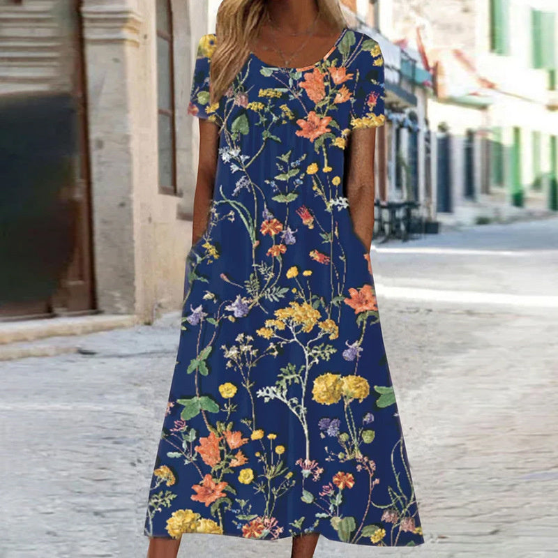 Woman wearing a blue floral dress on a street.