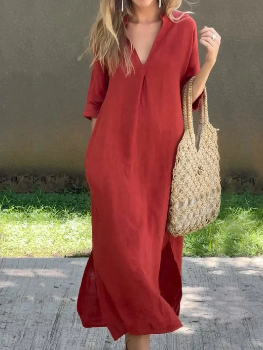 Woman wearing a red dress holding a woven bag outdoors.