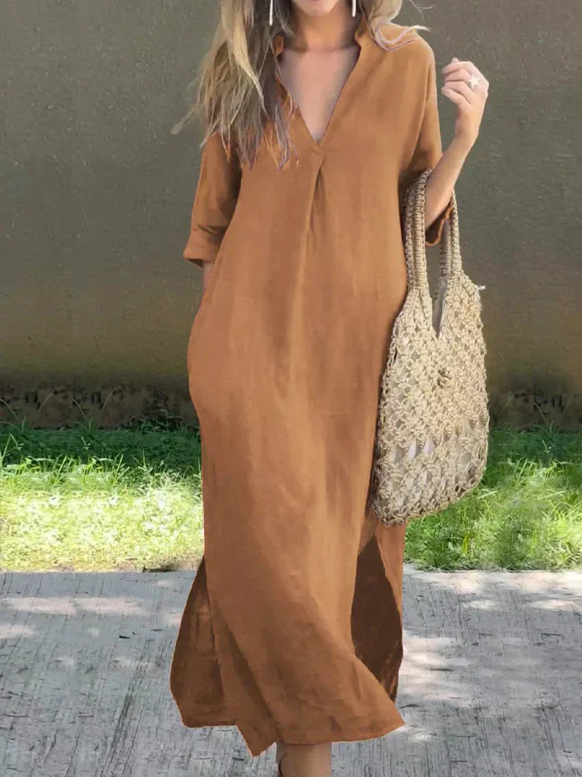 Woman wearing a brown dress holding a woven bag outdoors.